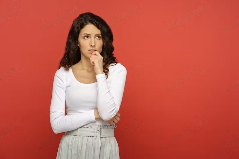 Wearing Spanx During Pregnancy – Is it OK. Portrait of a serious doubtful woman looking up thinking pensive and confused.