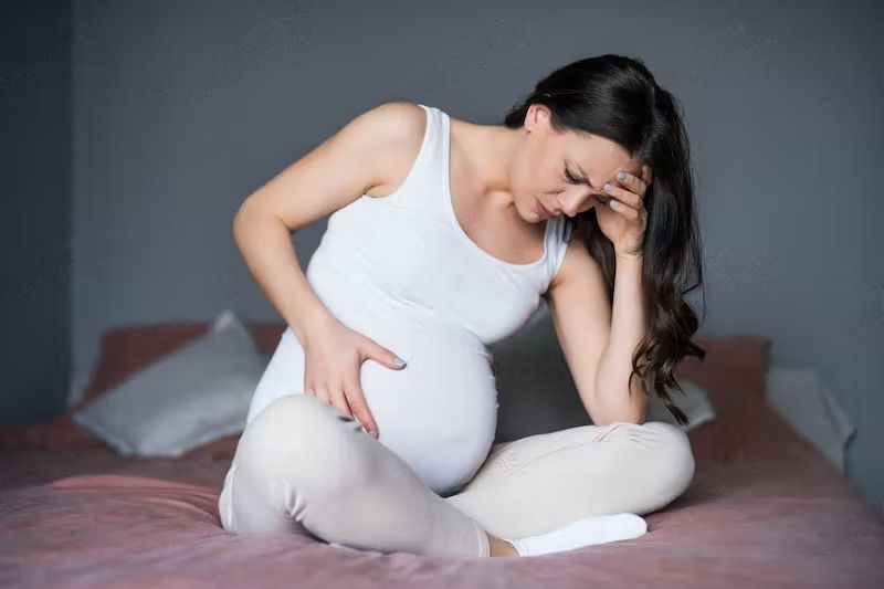 What Are Common Discomforts During Pregnancy? A pregnant woman is having pain in her stomach.
