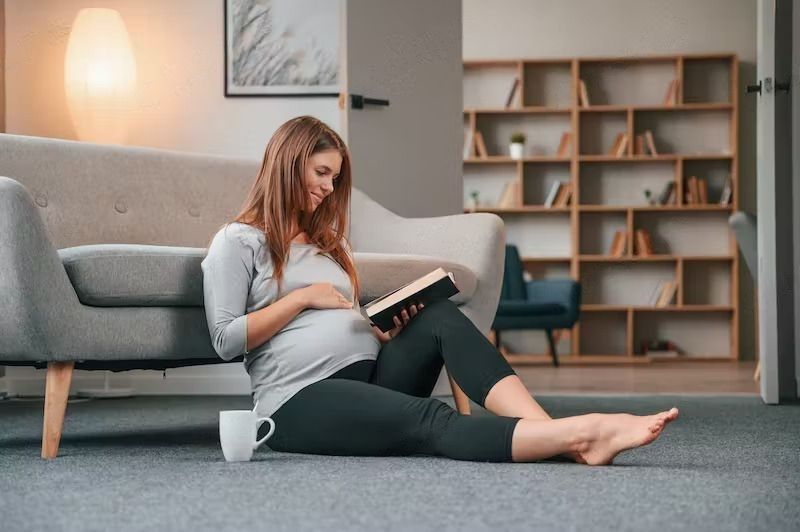 Pregnancy Tips And Ideas To Make The Road Smoother- A beautiful pregnant woman is indoors at home.

