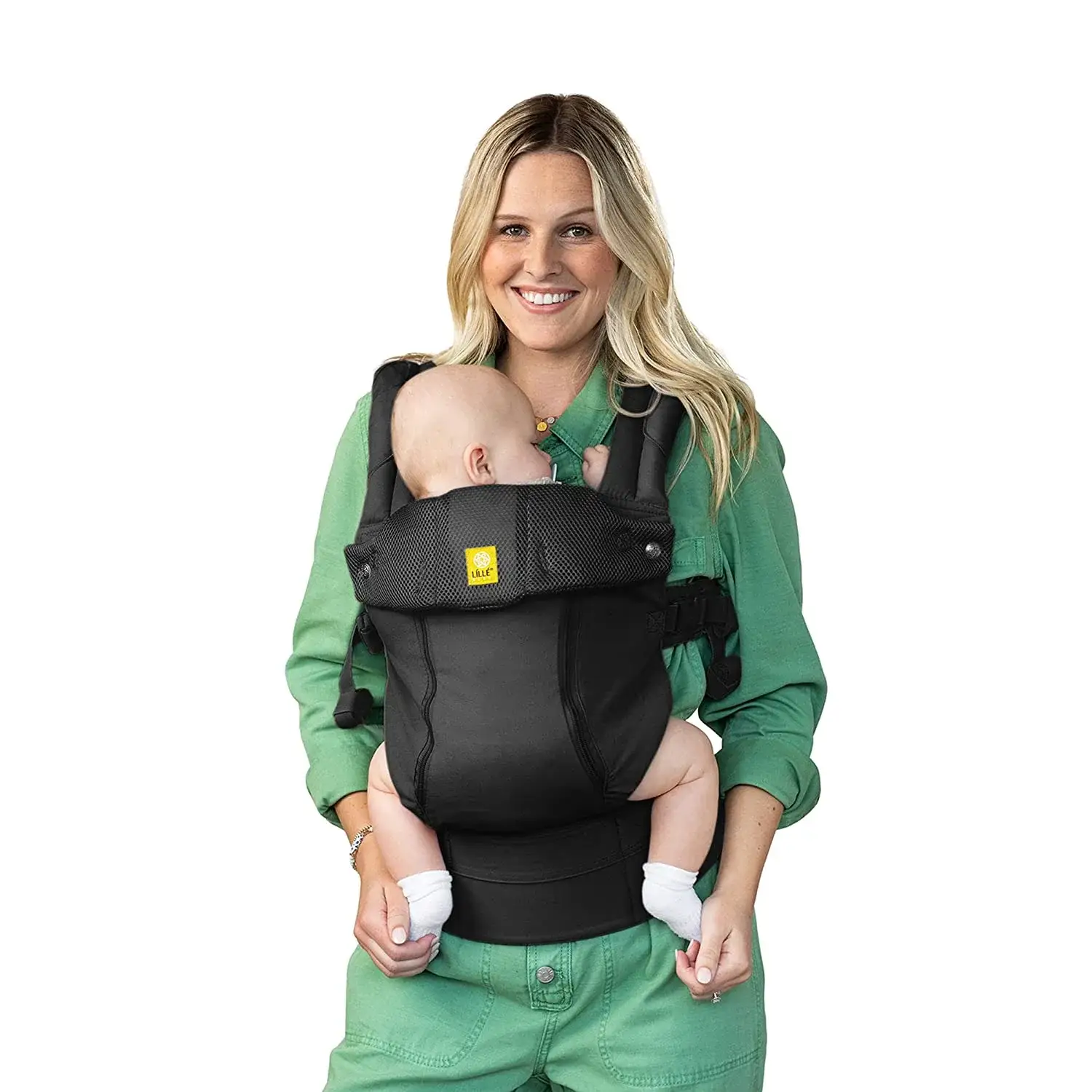 A mother carrying her sleeping baby in a baby carrier - Top 10 Baby Carriers to Buy