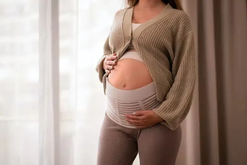 A pregnant woman wearing comfortable, pregnancy support belt