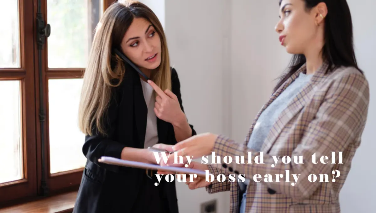 a pregnant woman talking with her boss