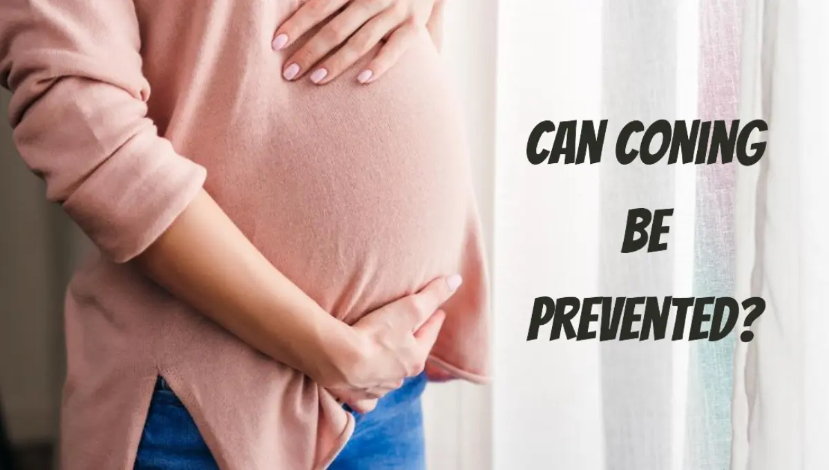 a pregnant woman touching belly while standing near window at home