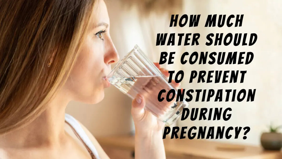 Happy pregnant lady holding glass of water.
