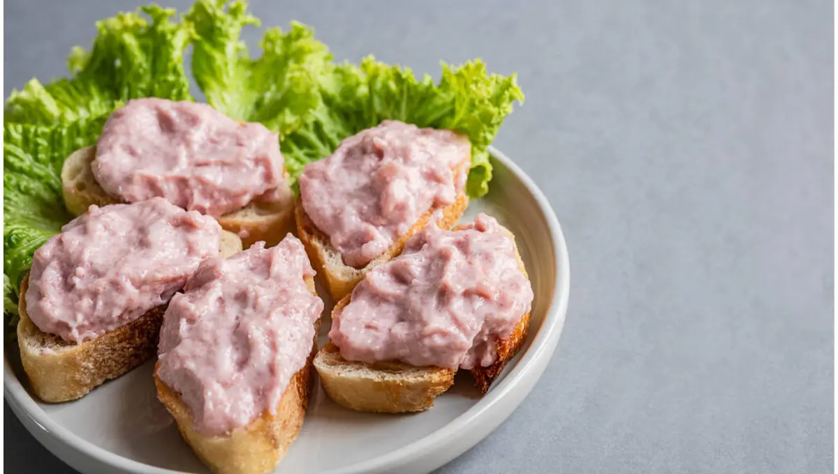 Toasts with tarama or taramasalata canape on a plate with salad