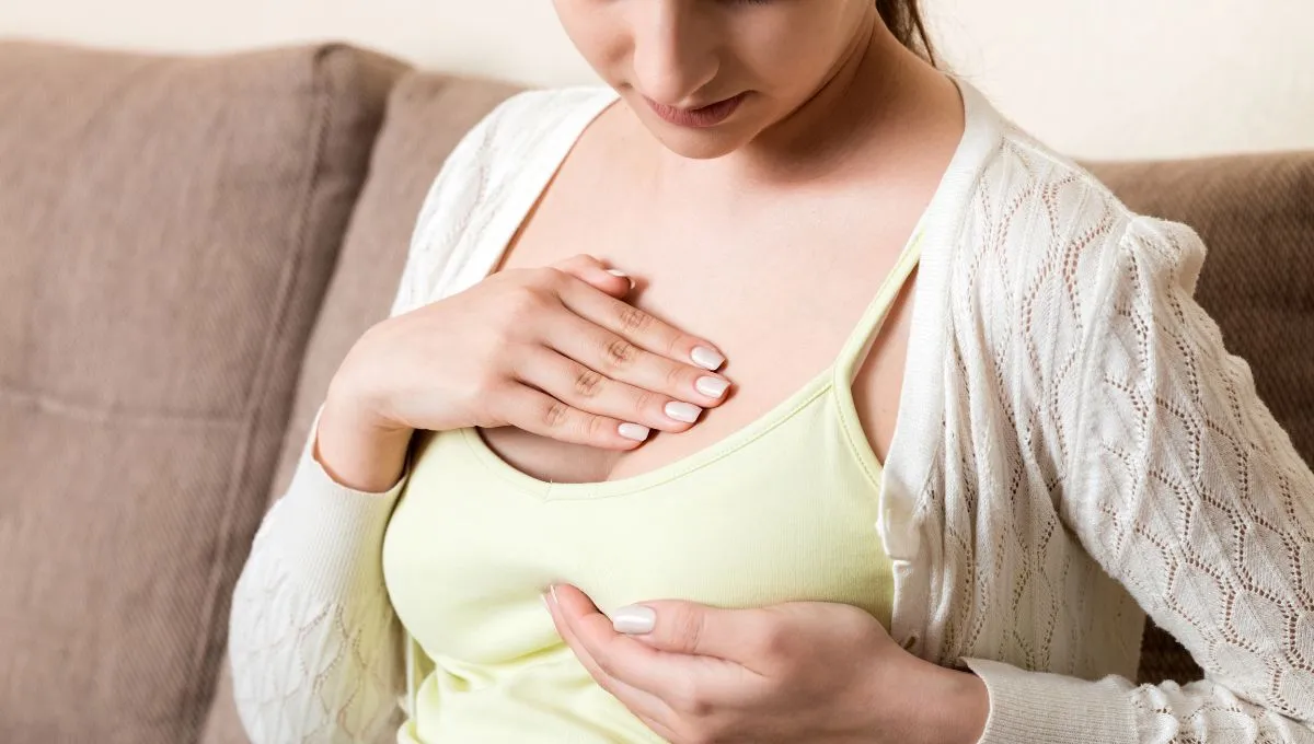 a woman experiencing breast pain.