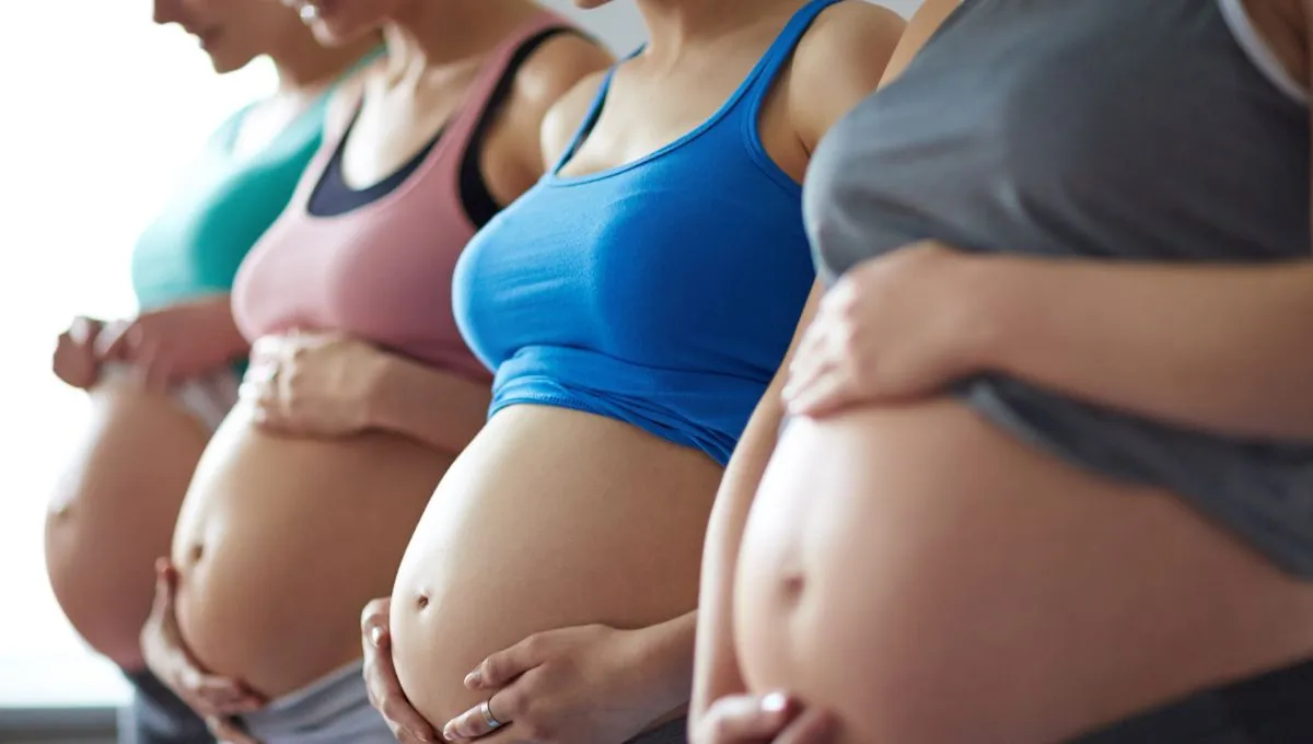 a group of pregnant woman showing their pregnant bellies