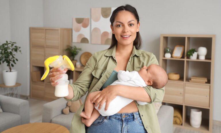 a mother showing the breast pump whle holding her baby in her arms